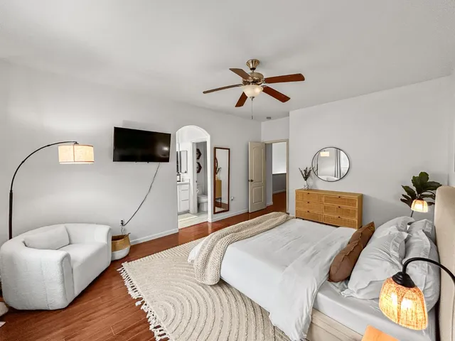 a bathroom with a double vanity sink a toilet a mirror and shower