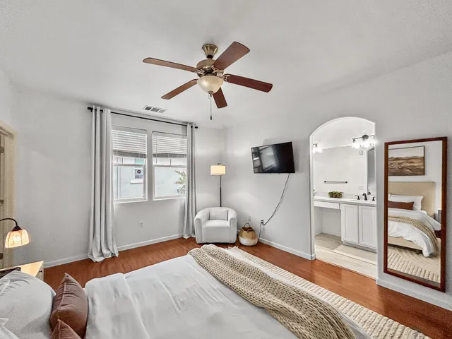 a workspace with wooden floor and a chandelier
