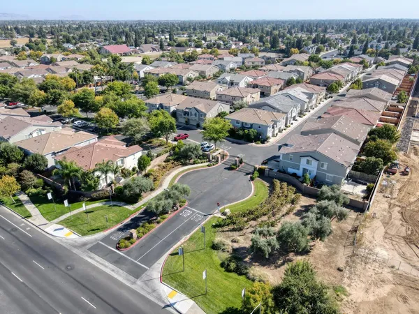 a view of yard from deck with patio