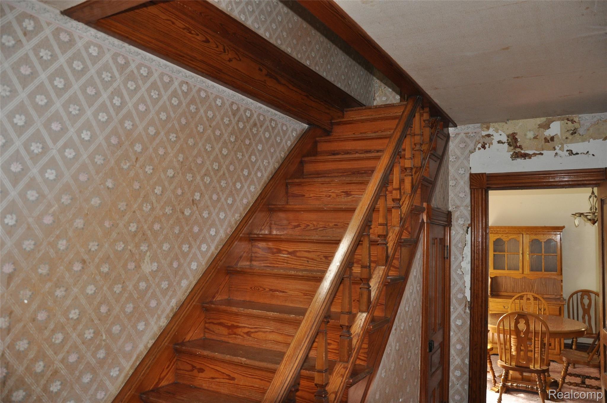 3954 Mayville Road Silverwood, MI 48760 - Photo 19 of 30 Hardwood staircase featuring turned balusters and a substantial newel post