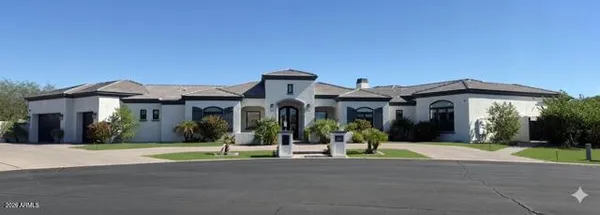 a view of a house with a yard in front of it
