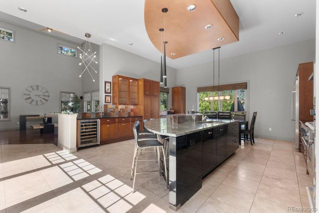 a kitchen with stainless steel appliances kitchen island granite countertop a sink and cabinets