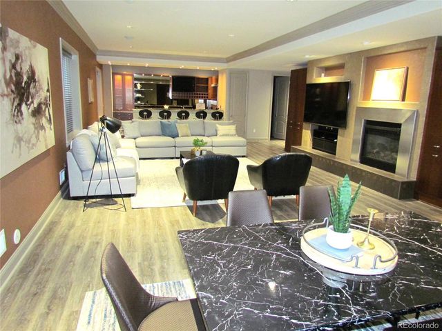 a living room with furniture a flat screen tv and a large window