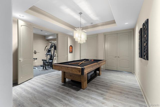 a room with wooden floor and ceiling fan
