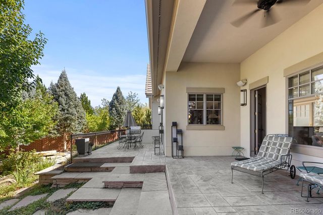 a view of a patio with table and chairs and potted plants