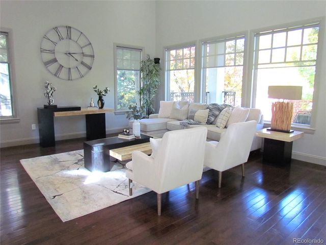 a living room with fireplace furniture and a large window