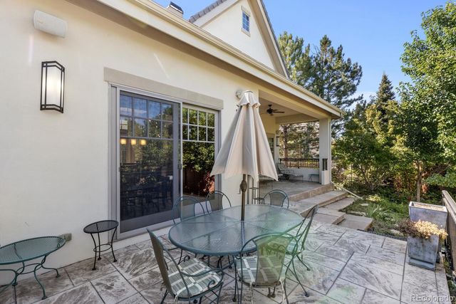 a patio with a table and chairs