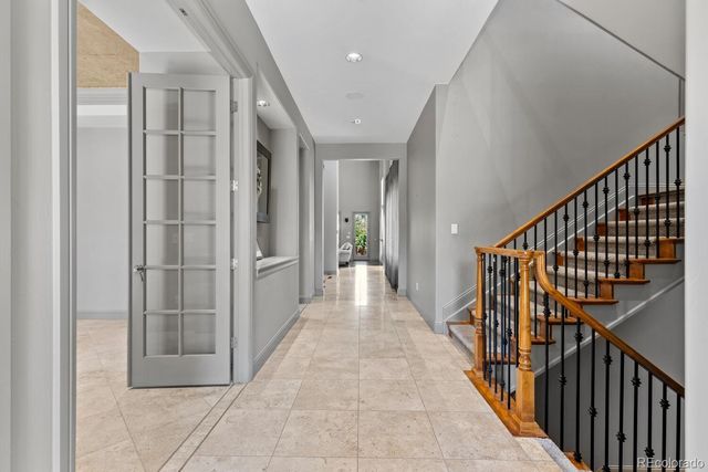 a view of a hallway with wooden floor and stairs