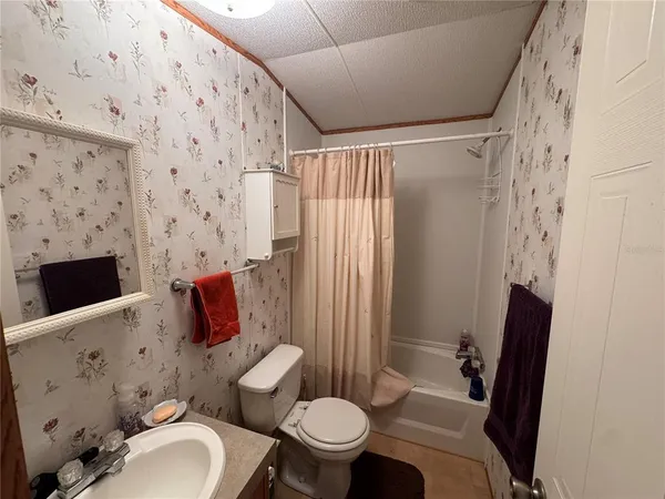 a bedroom with a bed and a mirror on the dresser