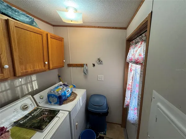 a bedroom with a bed and a refrigerator