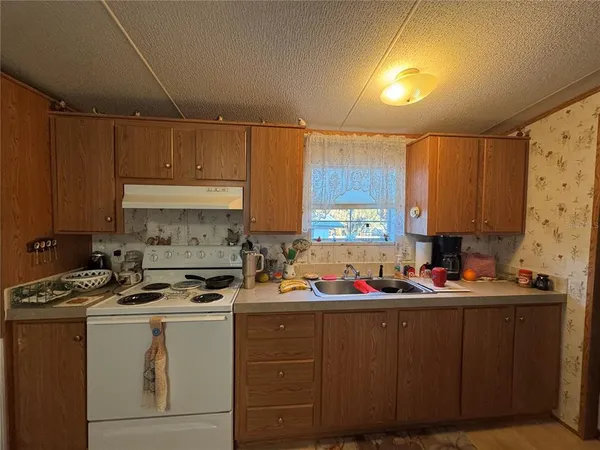 a spacious bedroom with a bed and a chandelier