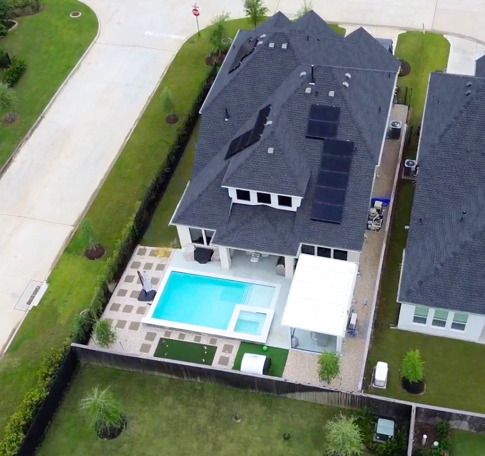 26918 Swanborough Road Spring, TX 77389 - Photo 42 of 50 This aerial view captures it all: a private, fully fenced cornet lot with a sparkling pool and spa, putting green, covered outdoor living space, and energy-efficient solar panels — premium upgrades throughout.