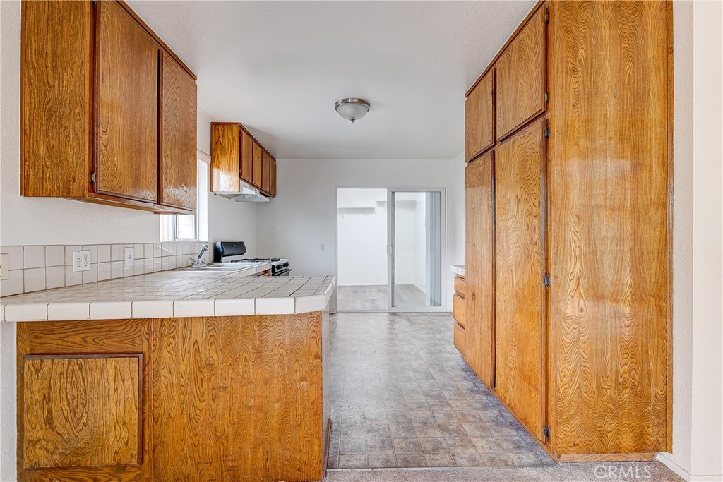 10139 Hillhaven Avenue Tujunga, CA 91042 - Photo 26 of 47 a kitchen with a sink a refrigerator and cabinets
