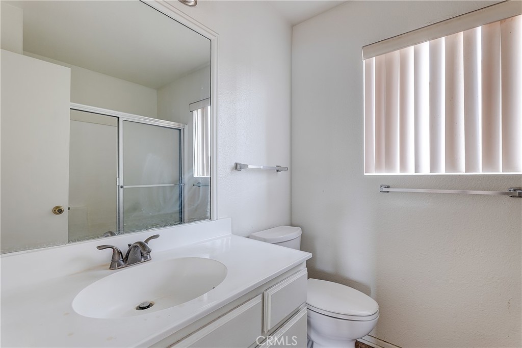 10139 Hillhaven Avenue Tujunga, CA 91042 - Photo 32 of 47 a bathroom with a toilet a sink and a mirror