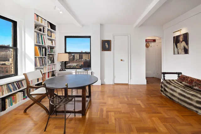 a living room with furniture and a bookshelf