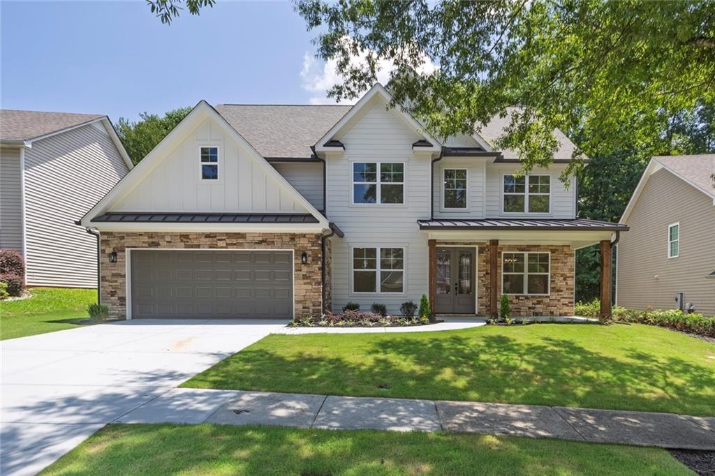 3460 Watson Gate Road Southwest Loganville, GA 30052 - Photo 1 of 1 a front view of a house with garden