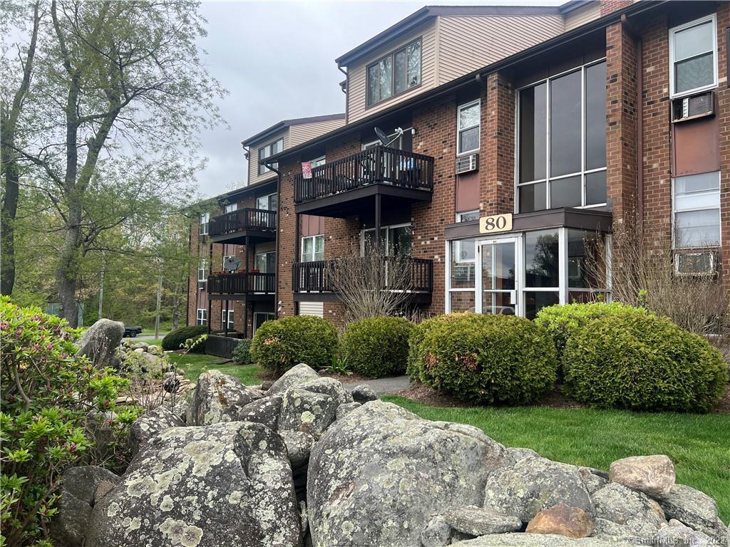 80 Balance Rock Road, Unit 4 Seymour, CT 06483 - Photo 1 of 1 a view of a brick house with a yard and plants