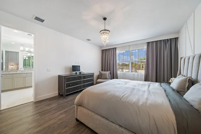 a bedroom with a bed and a flat tv screen