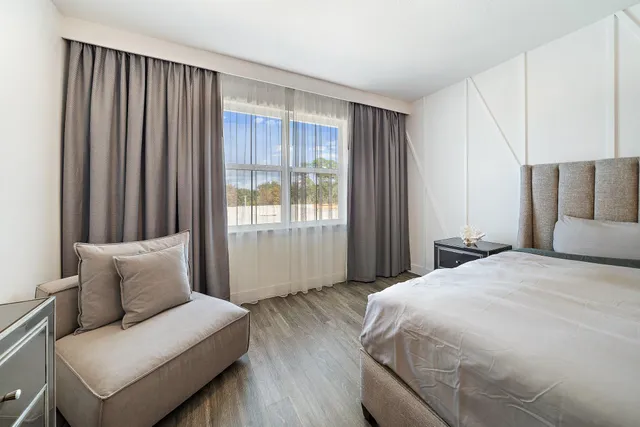 a bedroom with a bed and a couch