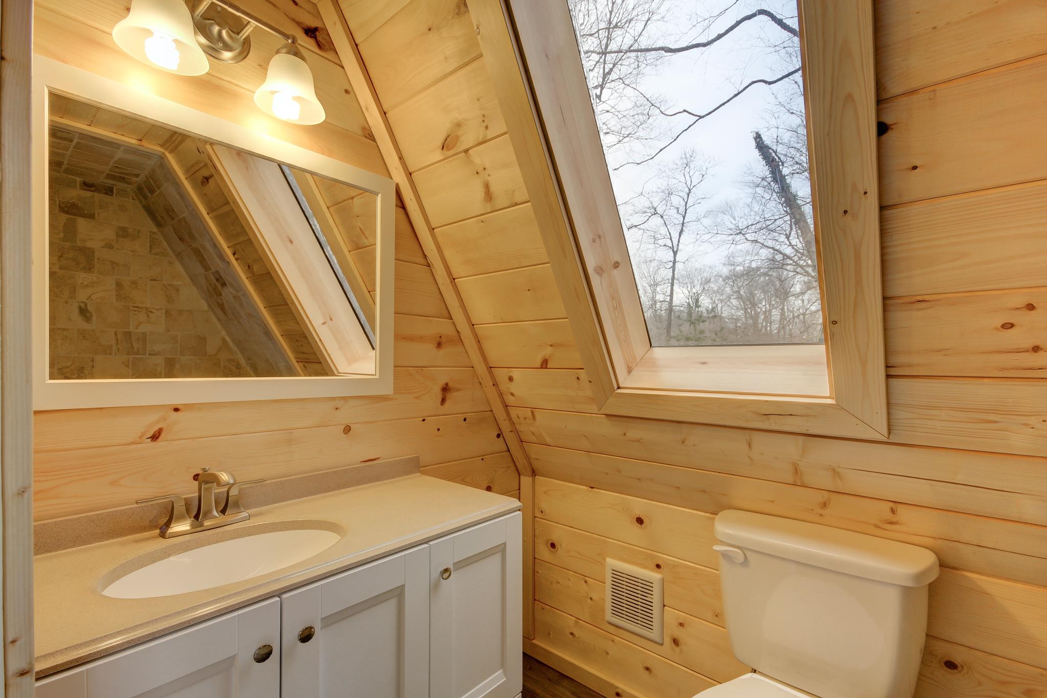 446 Harper Road Clarksville, TN 37043 - Photo 12 of 25 a bathroom with a sink and mirror with bathtub