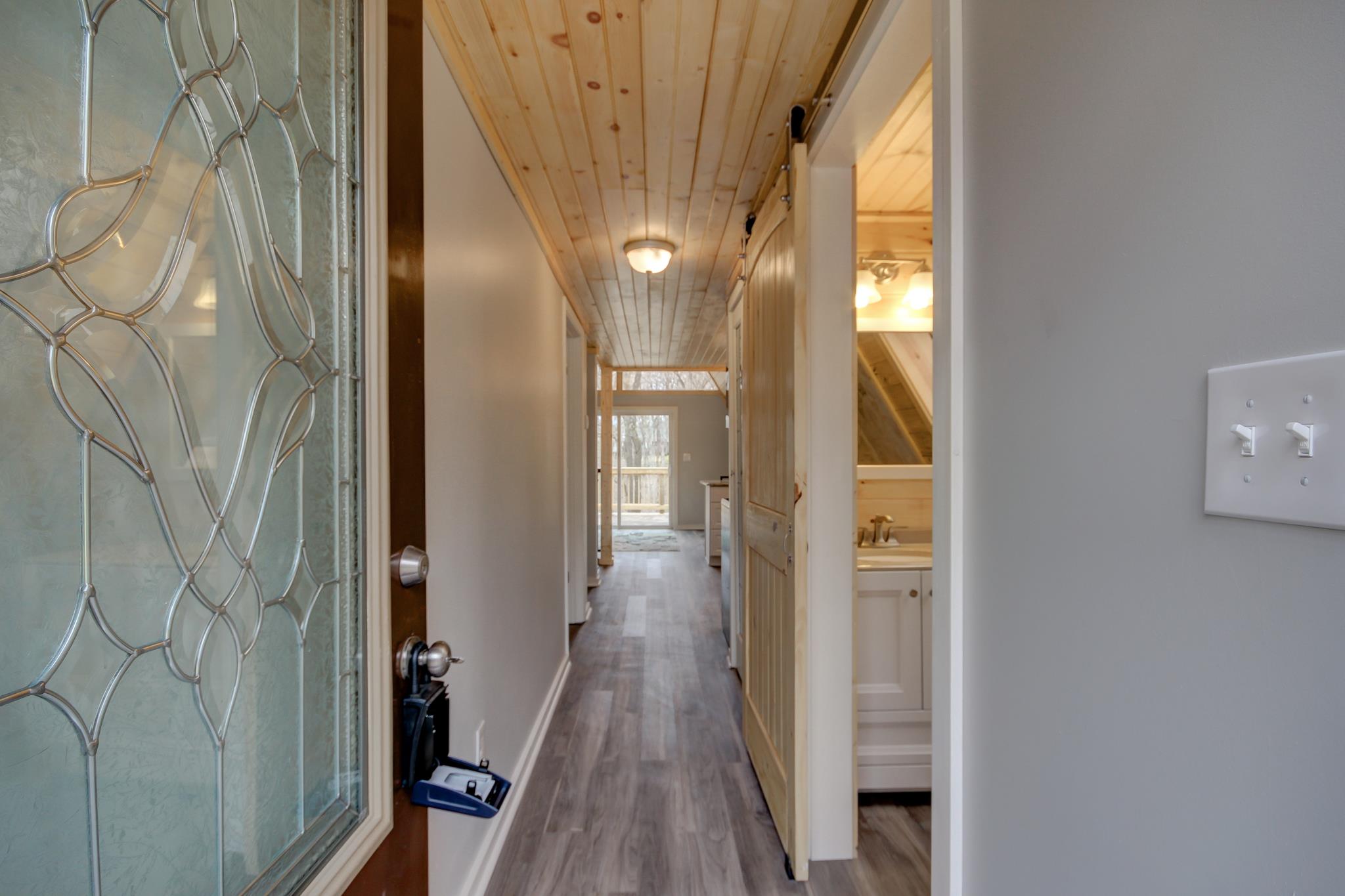 446 Harper Road Clarksville, TN 37043 - Photo 3 of 25 a view of a hallway with wooden floor and staircase