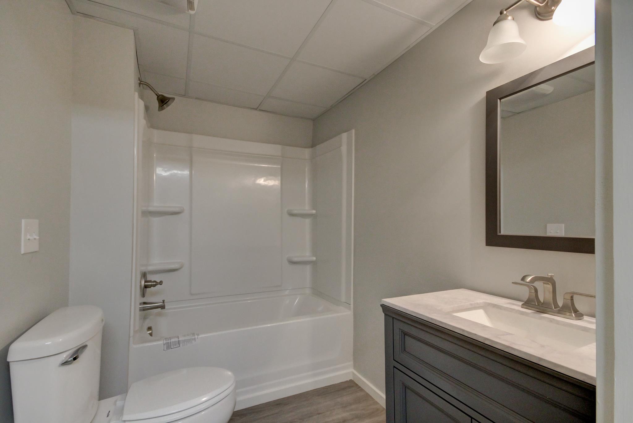 446 Harper Road Clarksville, TN 37043 - Photo 21 of 25 a bathroom with a granite countertop sink toilet and shower