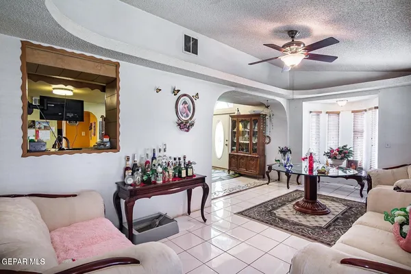 a living room with furniture and flowers
