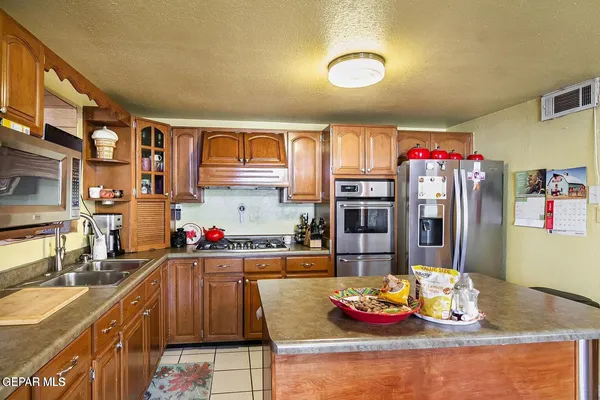 a kitchen with stainless steel appliances granite countertop a sink and dishwasher