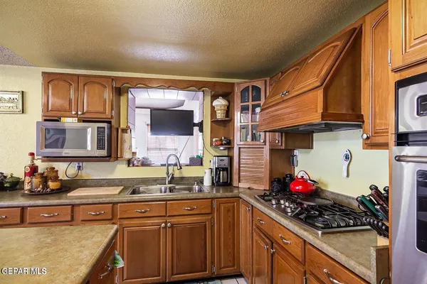 a kitchen with a sink cabinets and appliances