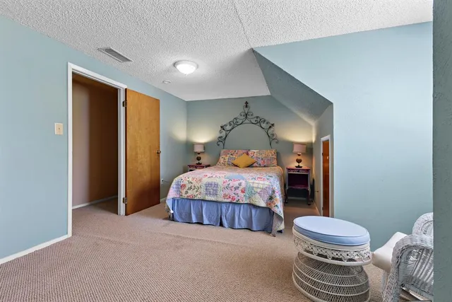 a bedroom with a bed and a closet