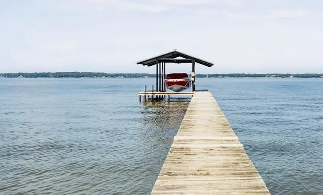a front view of a house with a lake