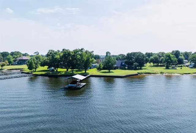 a view of a lake with houses in the back