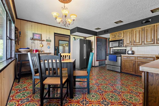 a view of a dining room with furniture a chandelier and wooden floor