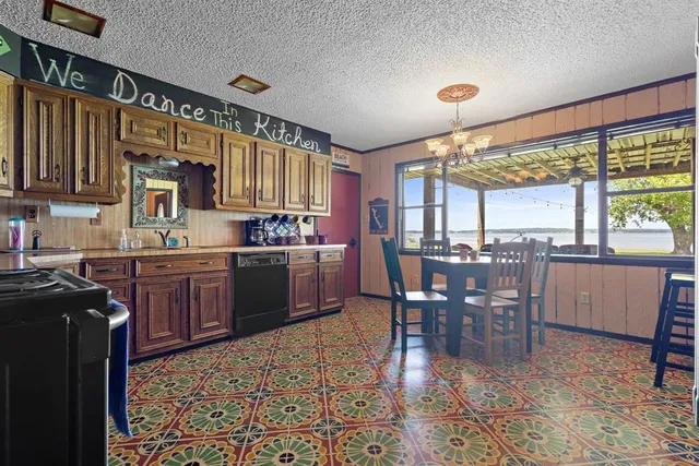 a kitchen with a table chairs sink and cabinets