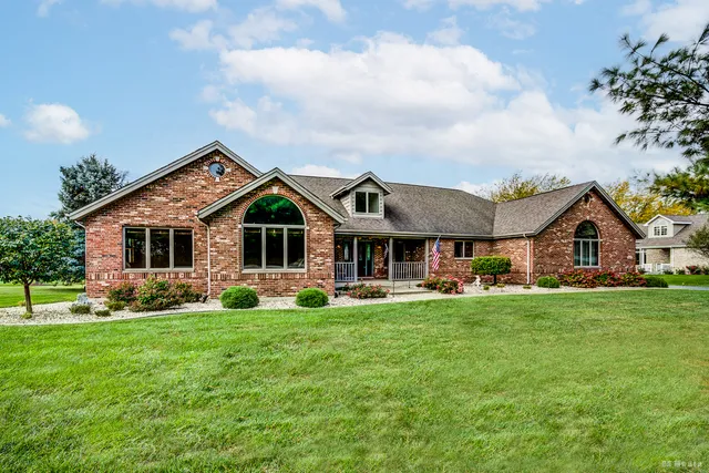 a front view of house with yard and green space
