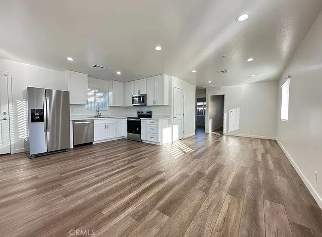 a view of a kitchen with a sink and a refrigerator