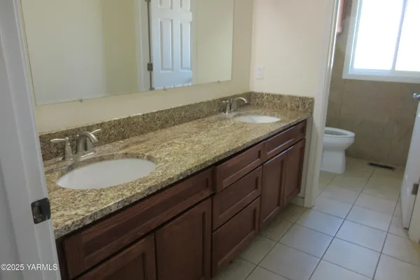 a bathroom with a granite countertop sink and a vanity