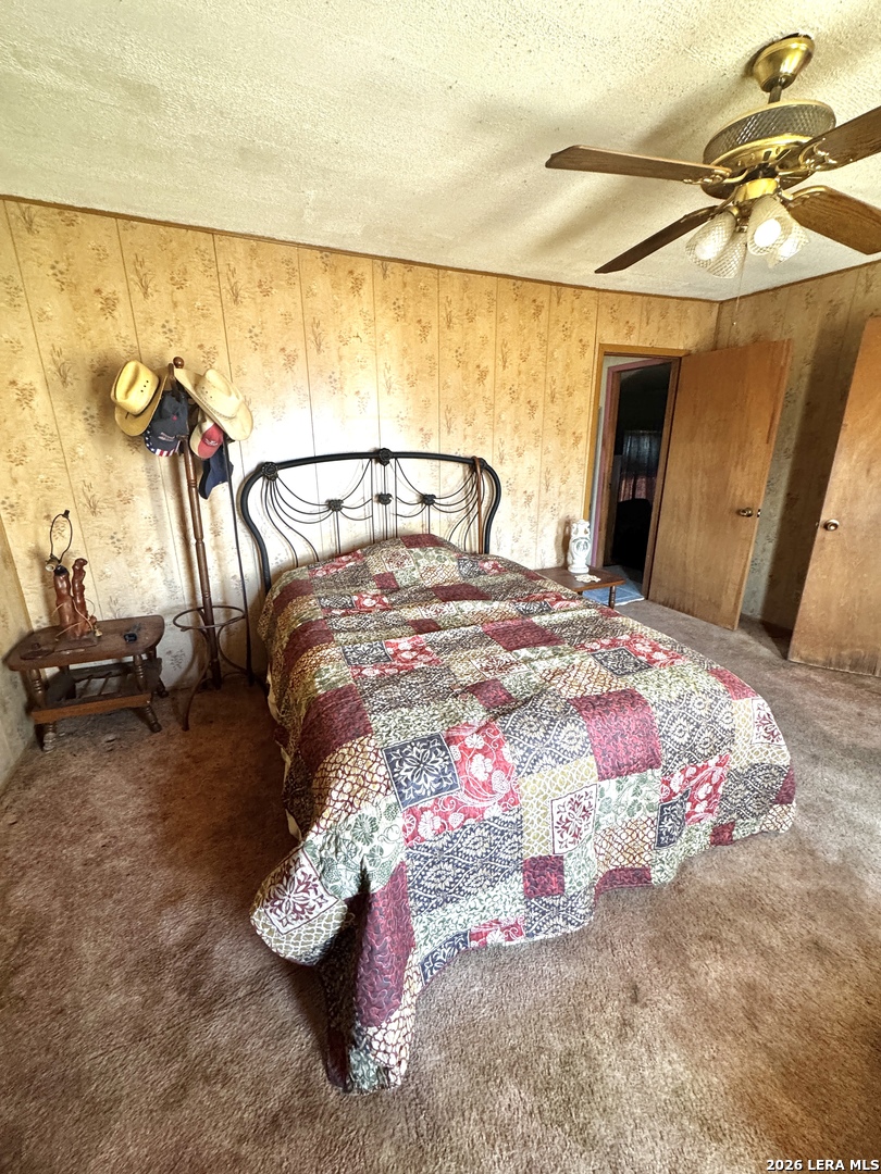 1580 Middle Road George West, TX 78022 - Photo 7 of 15 a bedroom with a bed and a night stand