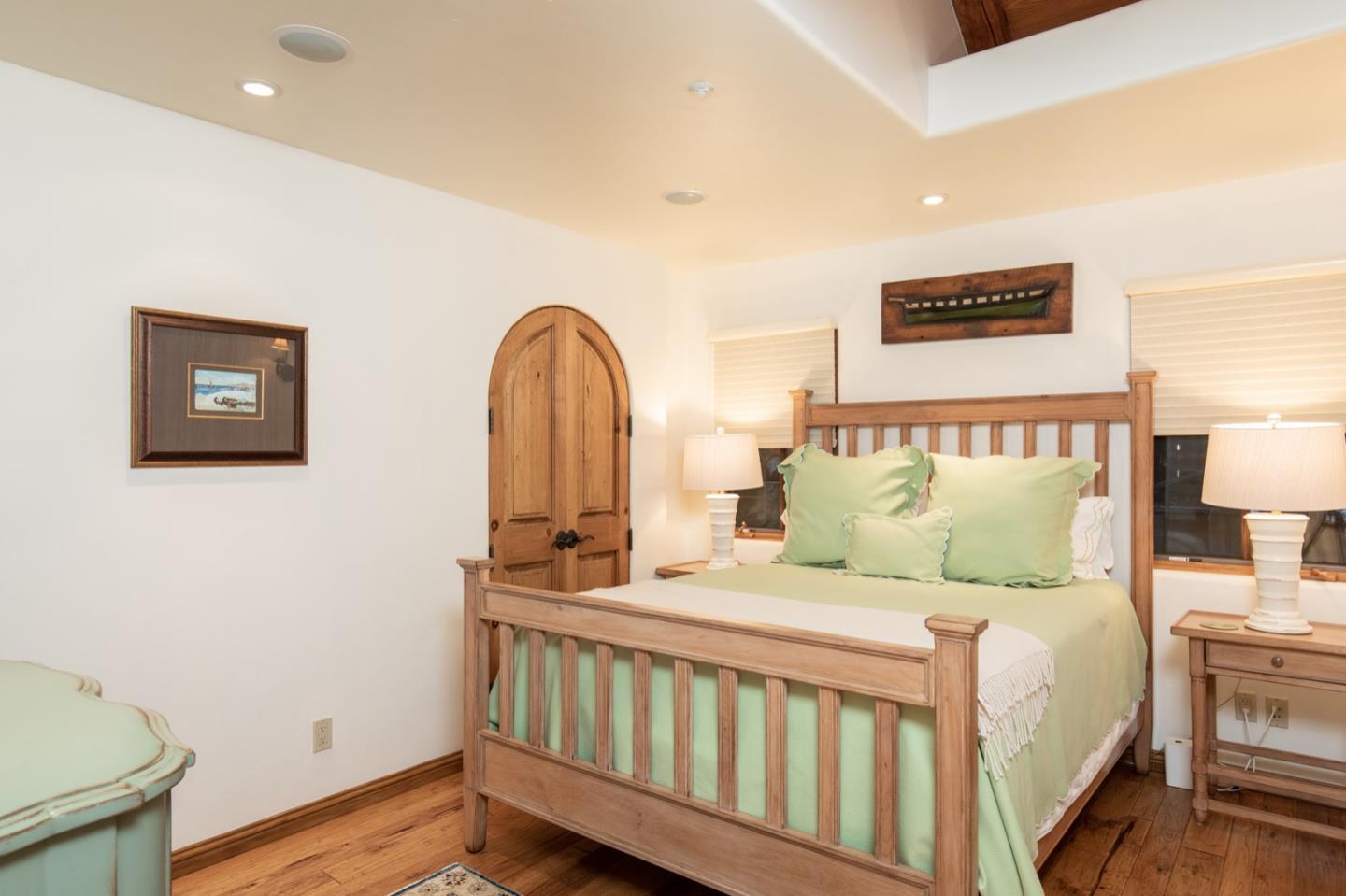 26255 Ocean View Avenue Carmel, CA 93923 - Photo 12 of 20 a bedroom with a bed and a night stand