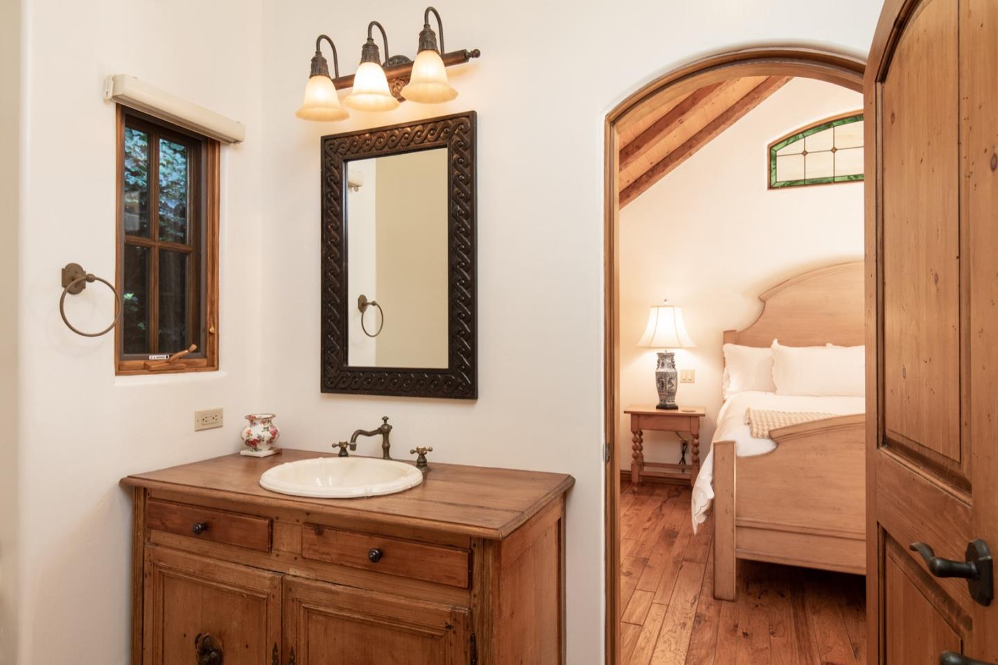 26255 Ocean View Avenue Carmel, CA 93923 - Photo 14 of 20 a en suite bathroom with a granite countertop sink and a mirror