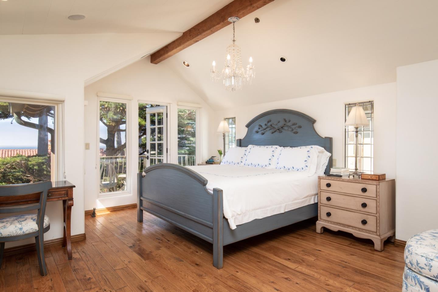 26255 Ocean View Avenue Carmel, CA 93923 - Photo 15 of 20 a bedroom with a bed and wooden floor