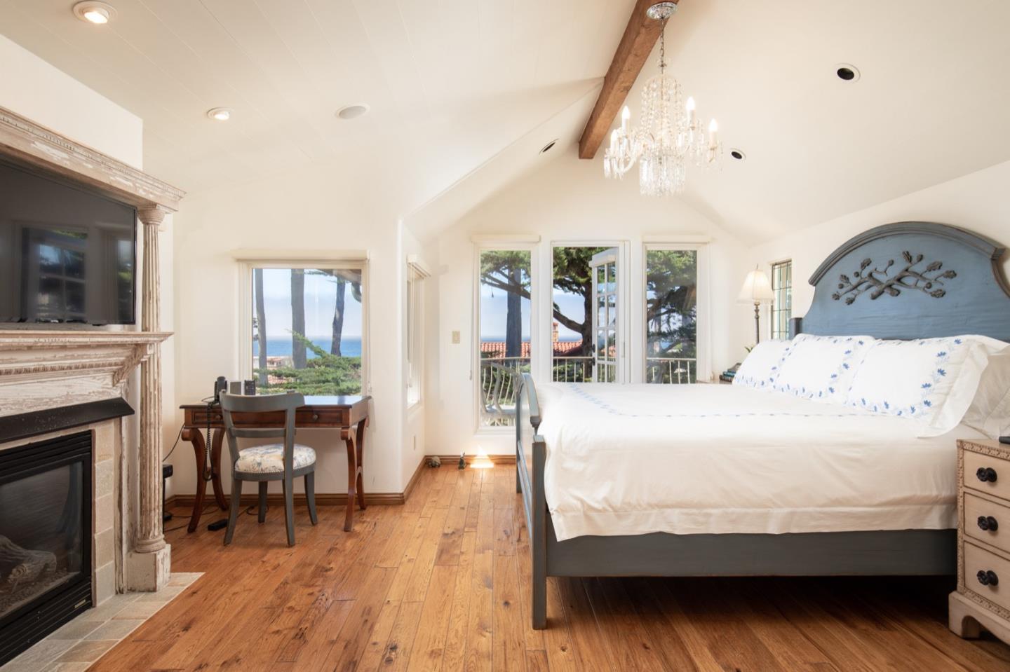 26255 Ocean View Avenue Carmel, CA 93923 - Photo 16 of 20 a bedroom with a bed and a fireplace