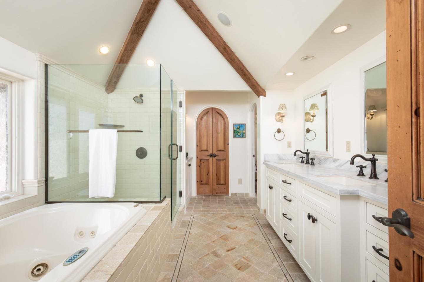 26255 Ocean View Avenue Carmel, CA 93923 - Photo 17 of 20 a spacious bathroom with a tub sink and mirror