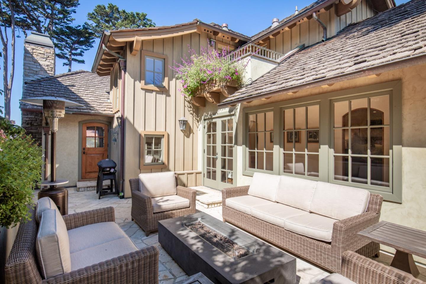 26255 Ocean View Avenue Carmel, CA 93923 - Photo 20 of 20 a view of a patio with couches table and chairs and potted plants