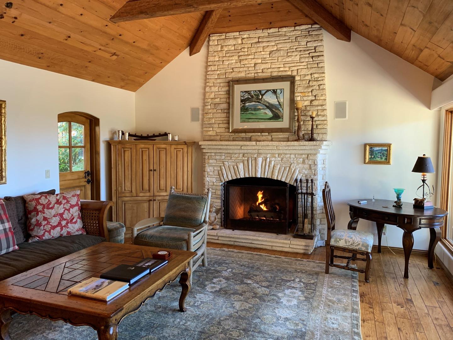 26255 Ocean View Avenue Carmel, CA 93923 - Photo 6 of 20 a living room with furniture and a fireplace