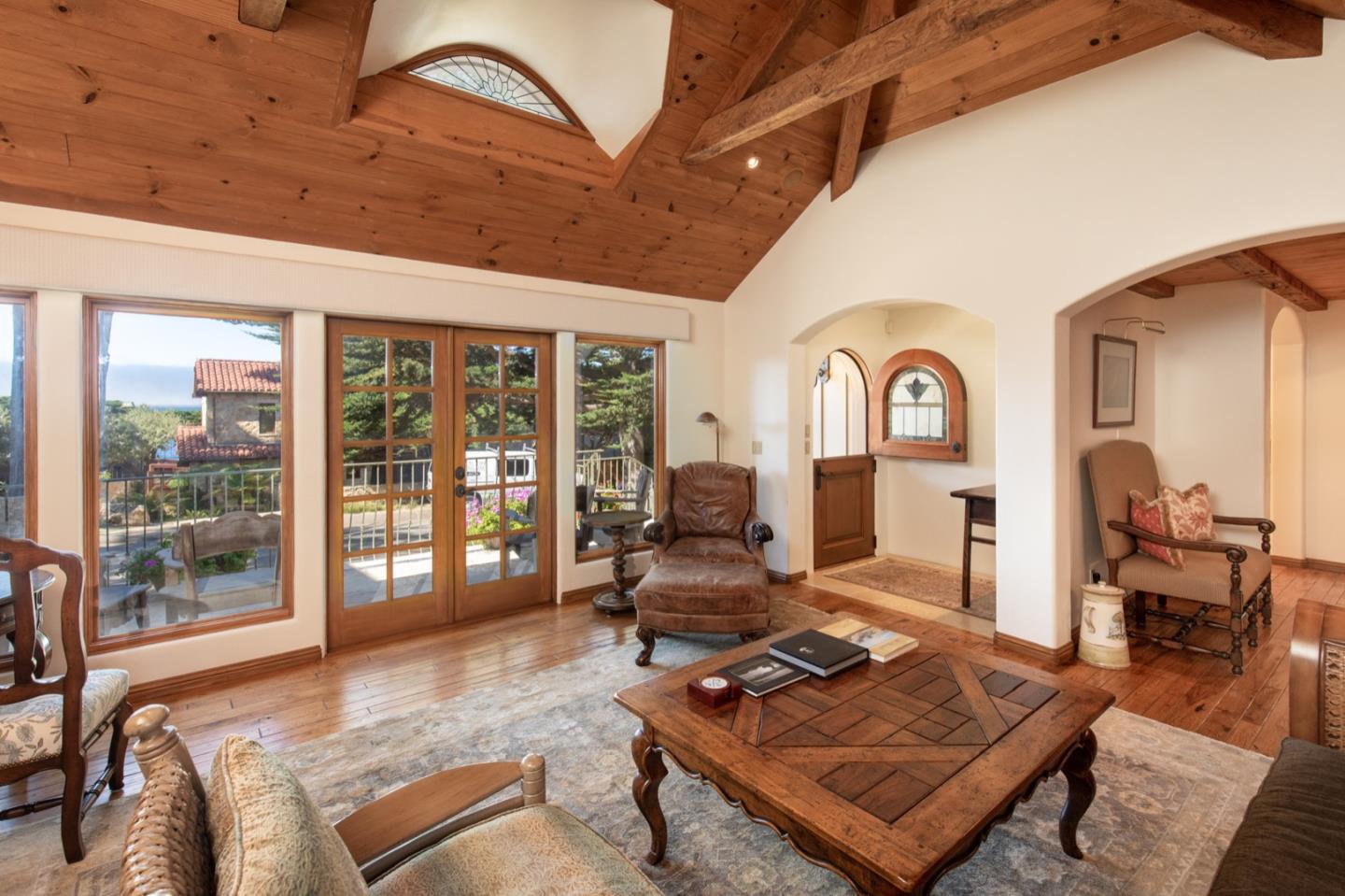 26255 Ocean View Avenue Carmel, CA 93923 - Photo 7 of 20 a living room with furniture a flat screen tv and a floor to ceiling window