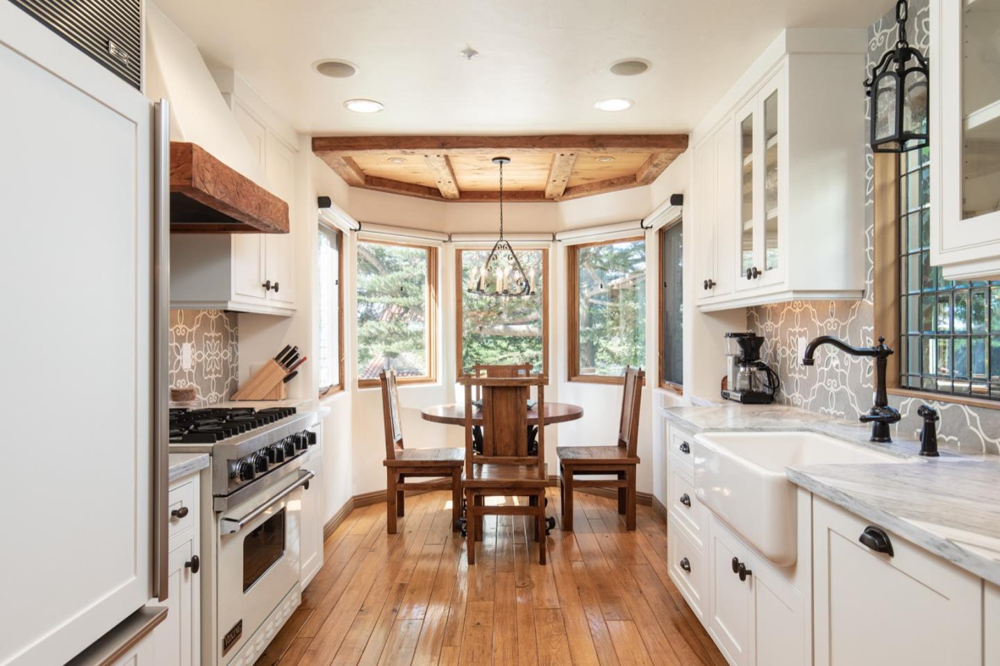 26255 Ocean View Avenue Carmel, CA 93923 - Photo 9 of 20 a large kitchen with a large window and cabinets