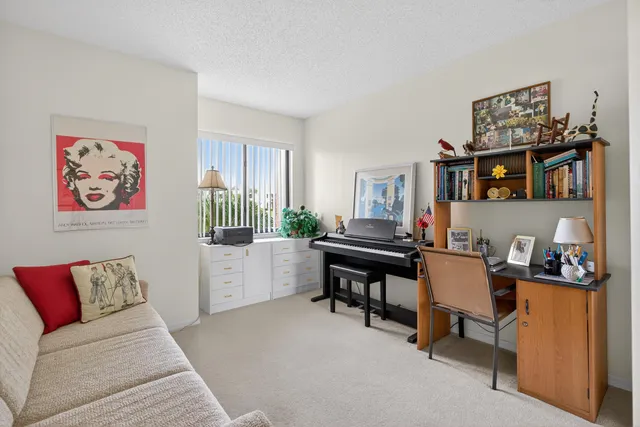 a living room with furniture and a piano