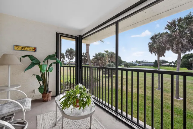 a living room filled with furniture and a potted plant