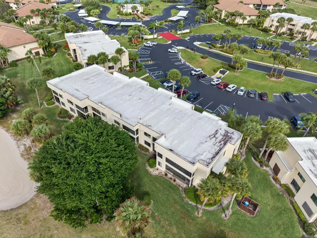an aerial view of a house with outdoor space and lake view